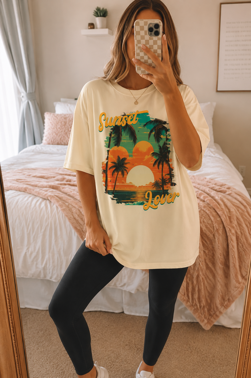 Comfort Colors Sunset Lover graphic t-shirt featuring retro palm trees and tropical sunset artwork modeled in a lifestyle mirror selfie